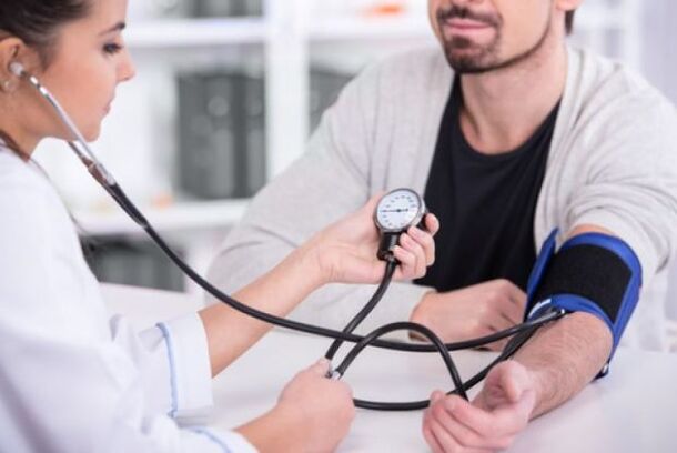 zdravnik meri krvni tlak pri hipertenziji